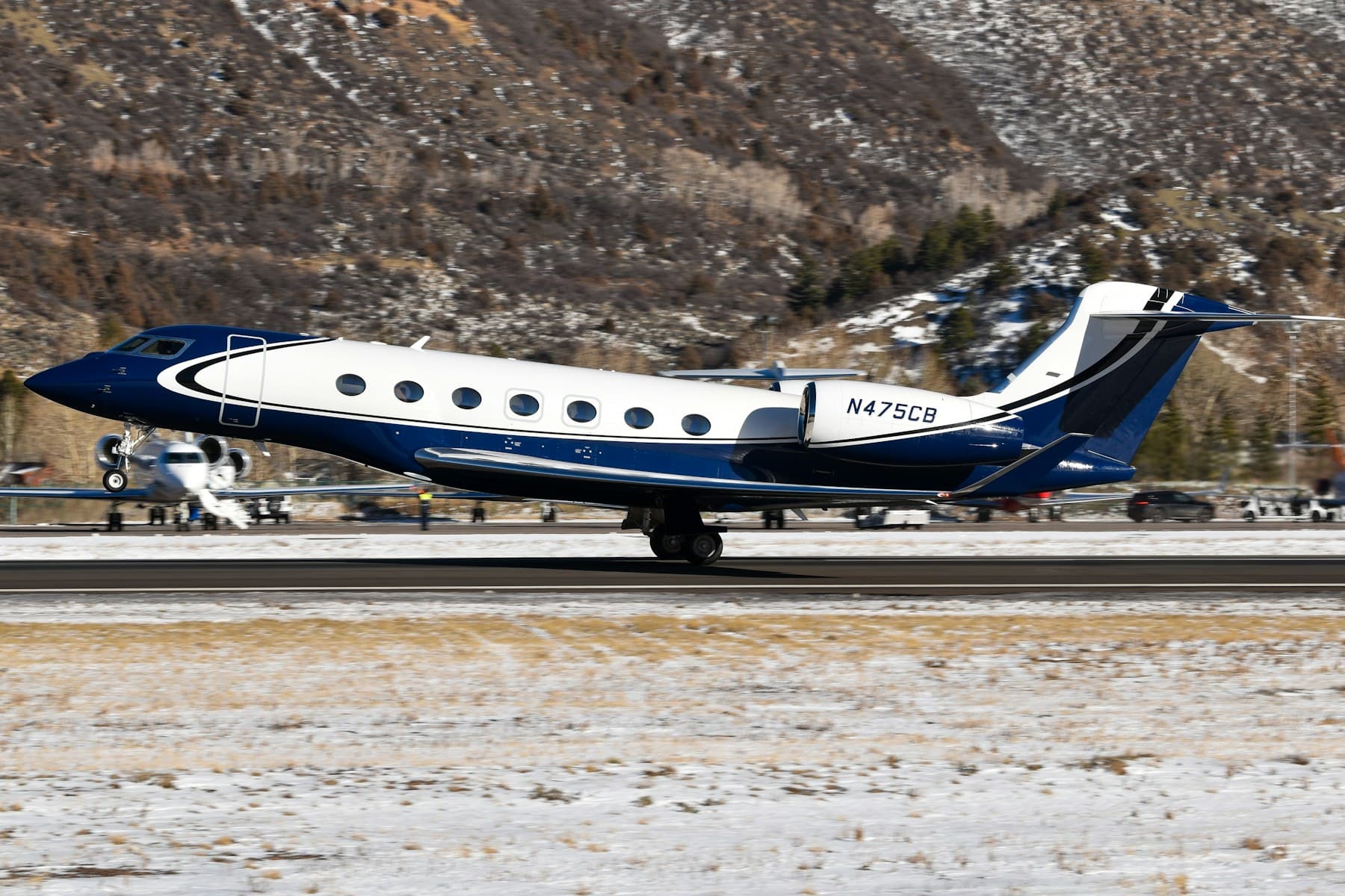 Gulfstream G650 business jet with FAA registration number N475CB departing a mountain runway