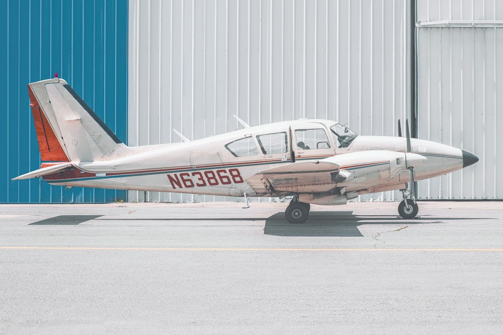 Twin-engine Piper airplane with FAA tail number N63868 in red lettering on the fuselage