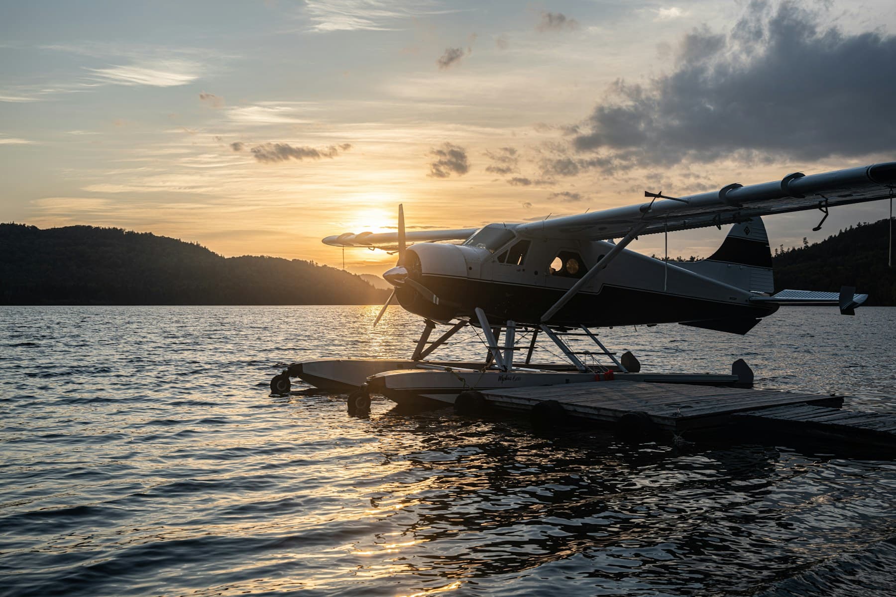 De Havilland Beaver floatplane at a lake dock at sunset, the classic seaplane for a custom N-number